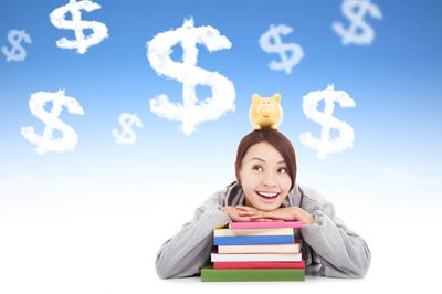 young girl with chin on stack of books - sees dollar signs clouds